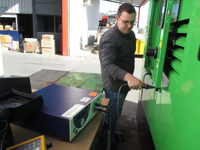 Taking measurements between the different metal parts on the generator set