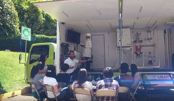 Students listening to the explanation of biodiesel generation in the "Steam Truck"